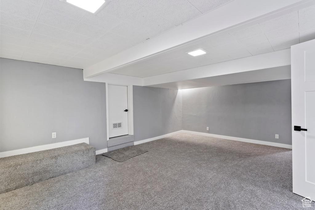 Finished below grade area with carpet flooring and baseboards