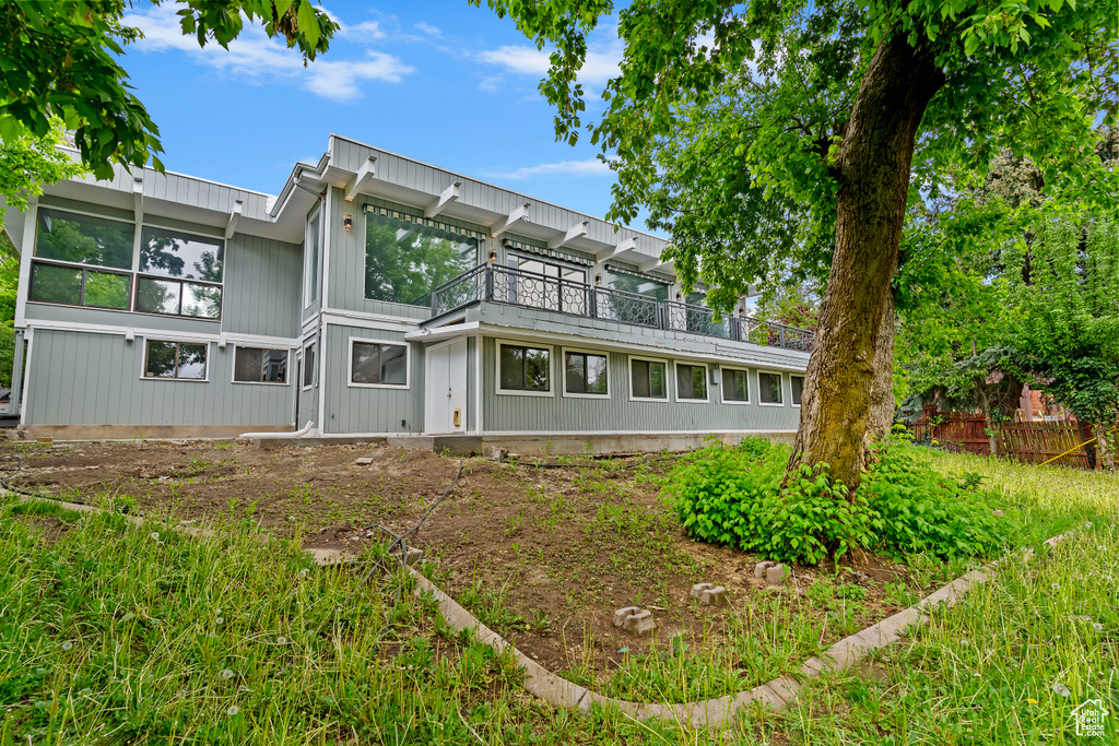 Back of house featuring a balcony
