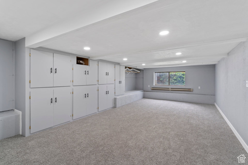 Basement featuring carpet, recessed lighting, and baseboard heating