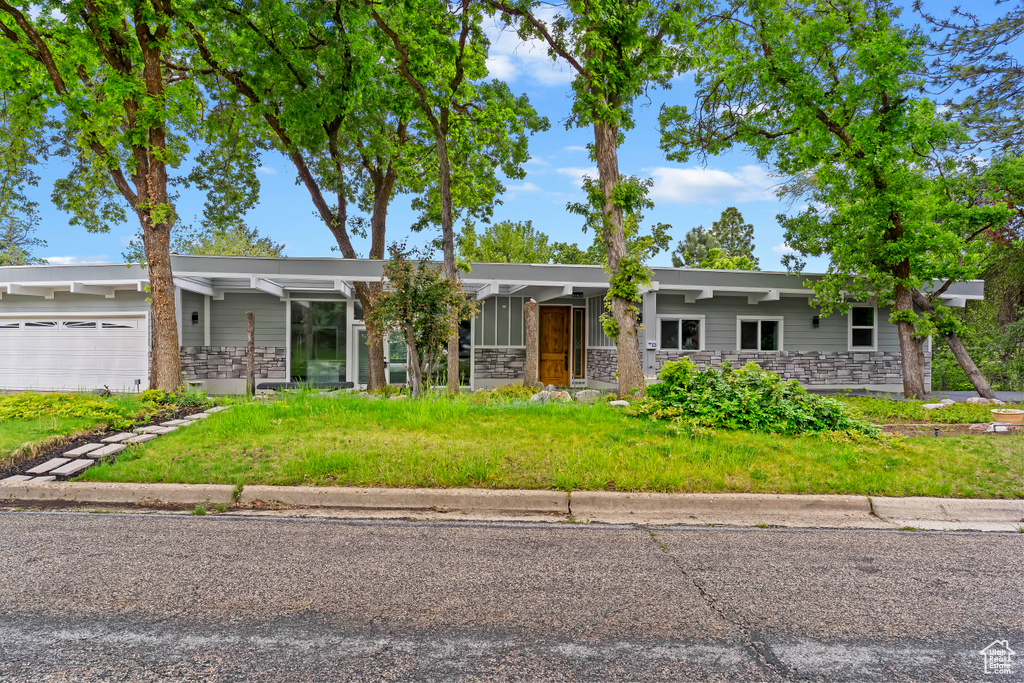Mid-century home with stone siding