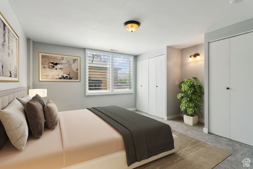 Carpeted bedroom featuring two closets