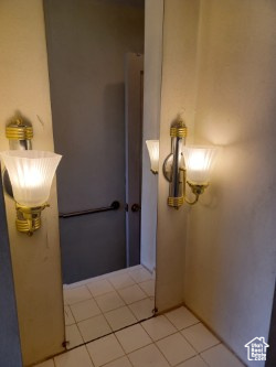 Bathroom with tile patterned floors and a chandelier