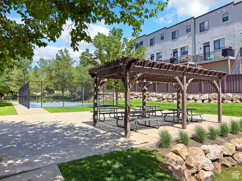 View of home\'s community featuring a pergola and a tennis court