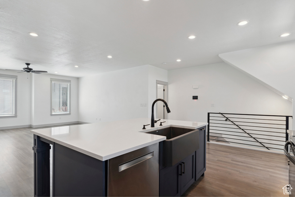 Kitchen with dishwasher, a sink, light wood-type flooring, ceiling fan, and recessed lighting