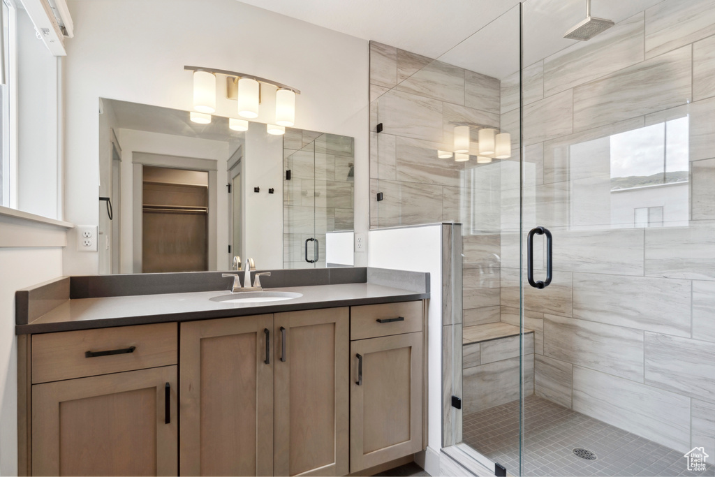 Bathroom with a stall shower and vanity
