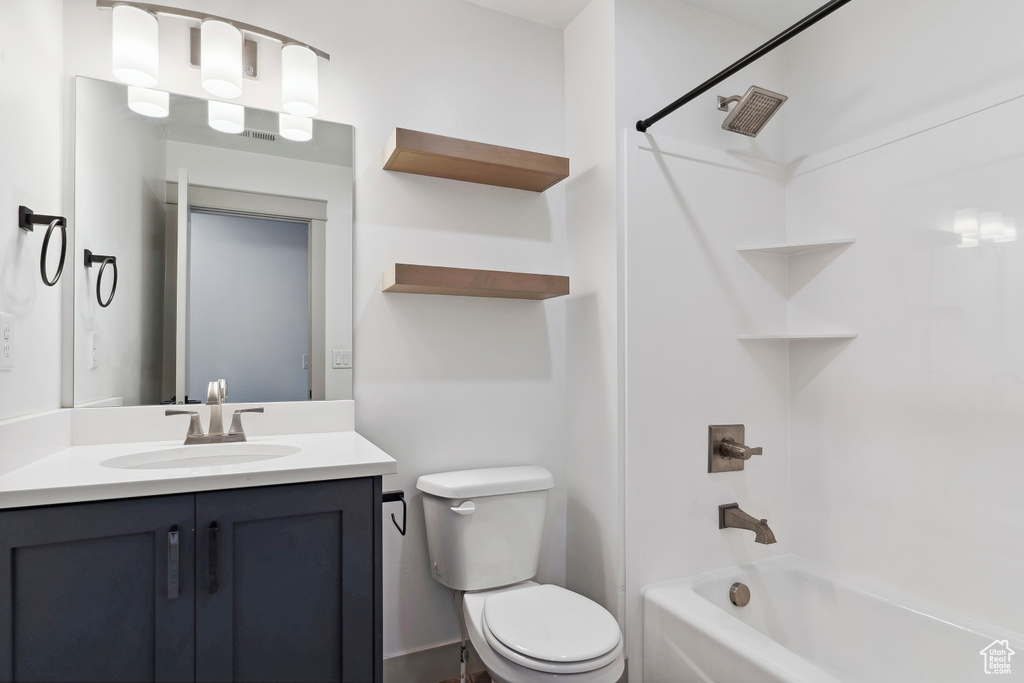 Full bathroom with toilet, bathing tub / shower combination, and vanity