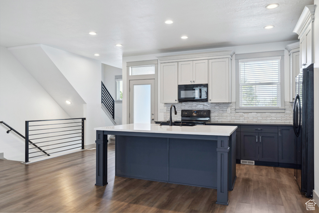 Kitchen featuring black appliances, a sink, tasteful backsplash, plenty of natural light, and recessed lighting
