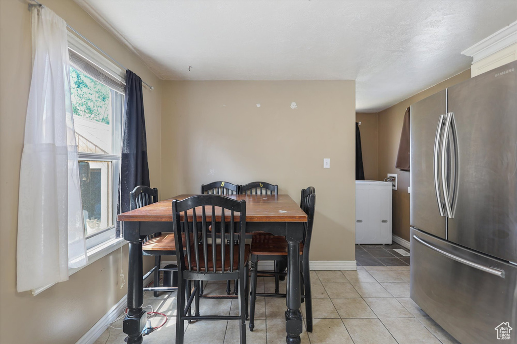 Dining area with baseboards and light tile patterned floors