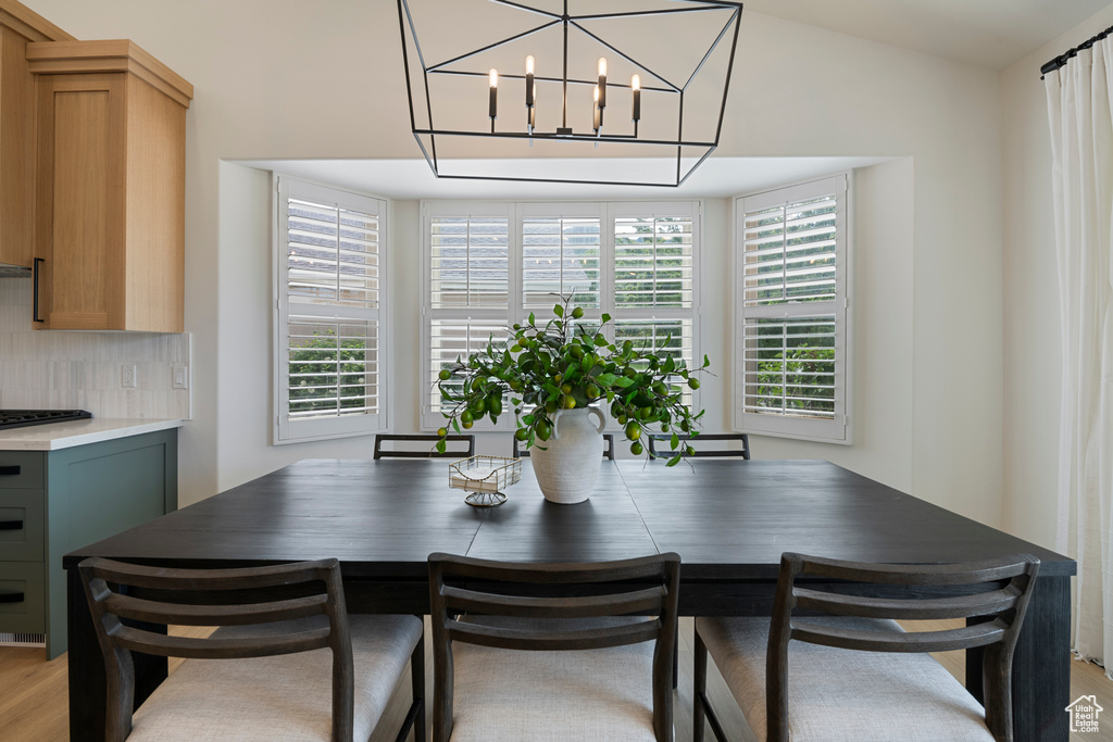 Dining area featuring light wood-style flooring and a chandelier
