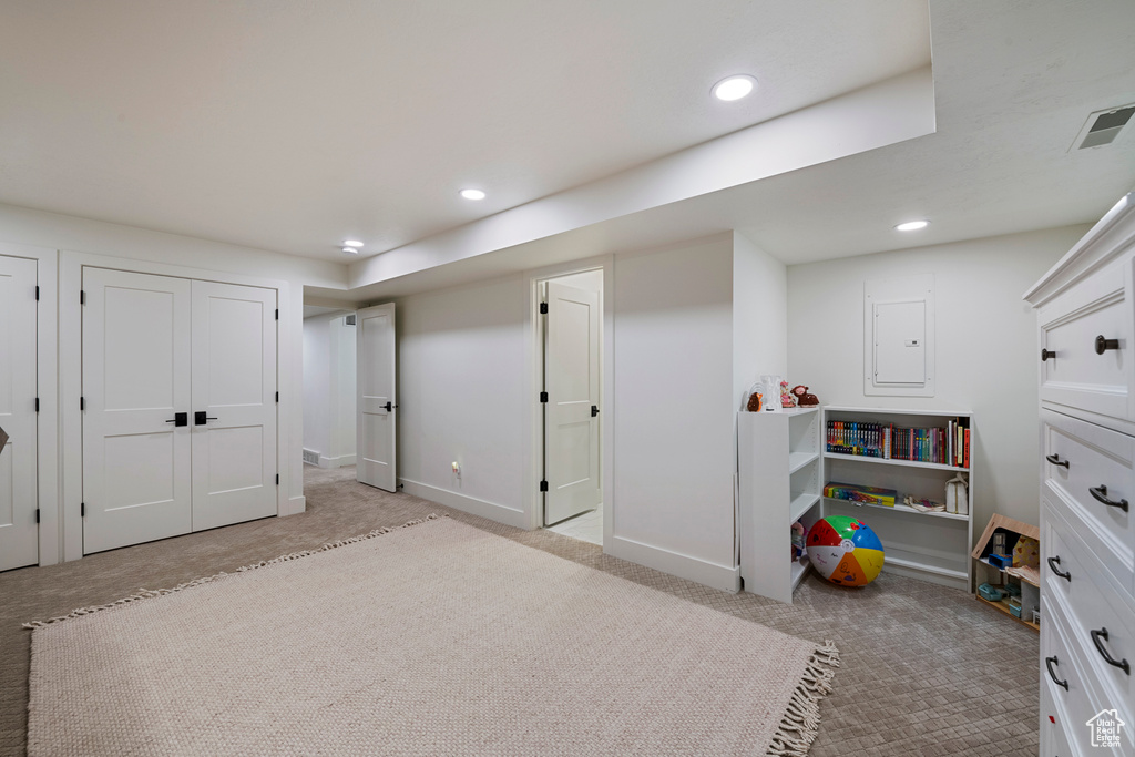 Bedroom with light colored carpet, recessed lighting, and baseboards