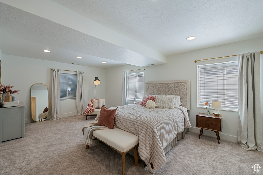 Bedroom featuring light colored carpet, baseboards, and recessed lighting