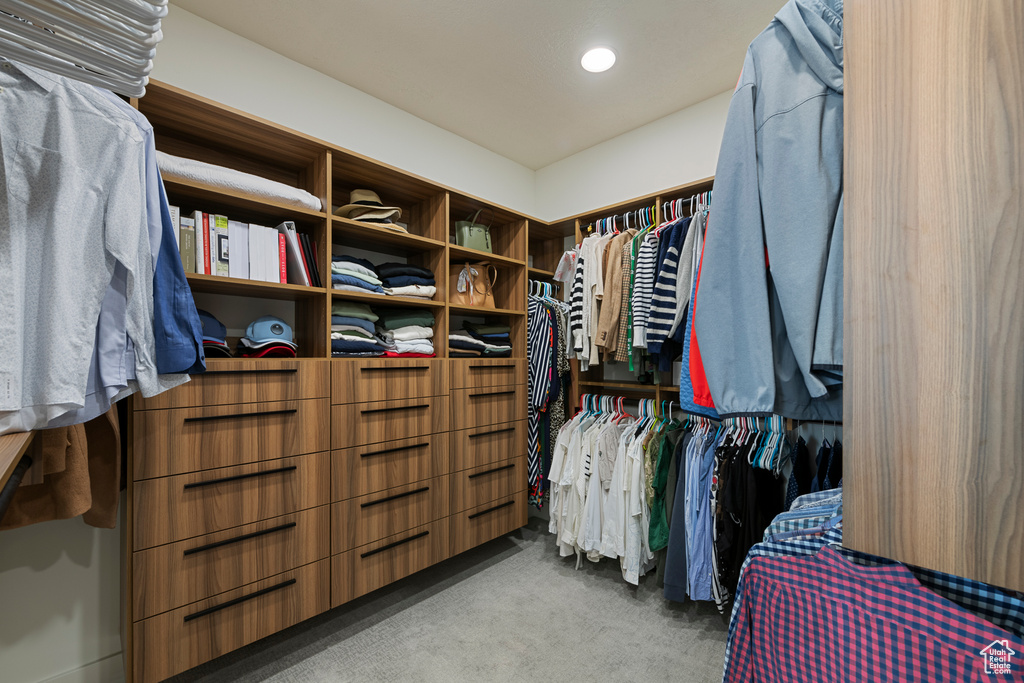 Walk in closet with carpet flooring