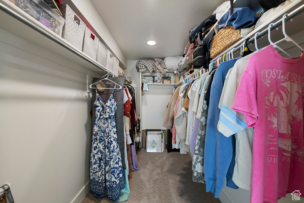 Walk in closet with carpet floors