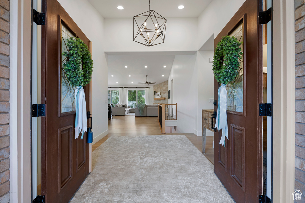 Entryway featuring wood finished floors, recessed lighting, a chandelier, and baseboards