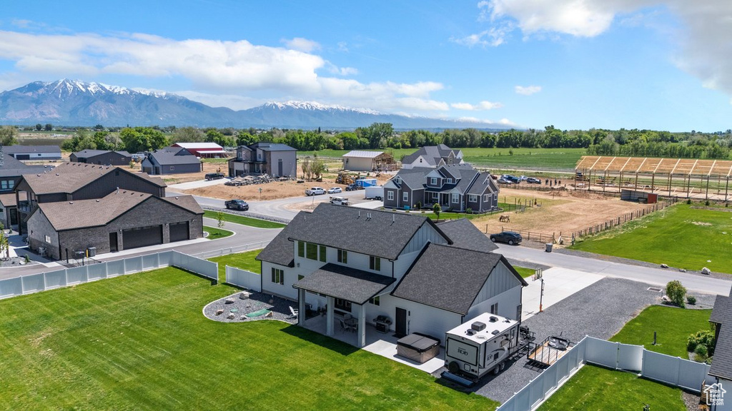 Aerial view of sparsely populated area with a mountain backdrop and nearby suburban area
