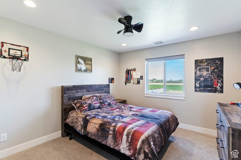 Bedroom featuring light carpet, recessed lighting, and baseboards