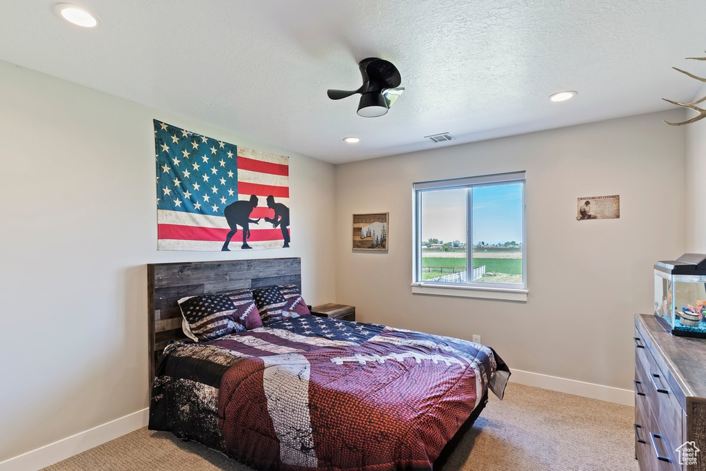 Bedroom with light colored carpet, baseboards, and recessed lighting