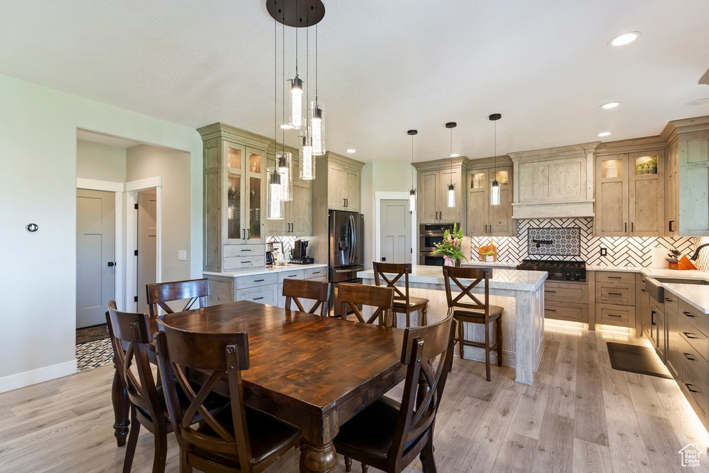 Dining area featuring light wood finished floors, recessed lighting, and baseboards