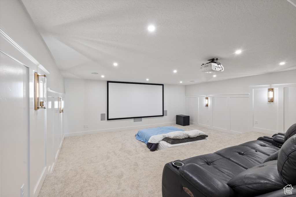 Home theater featuring carpet flooring, recessed lighting, a textured ceiling, and baseboards