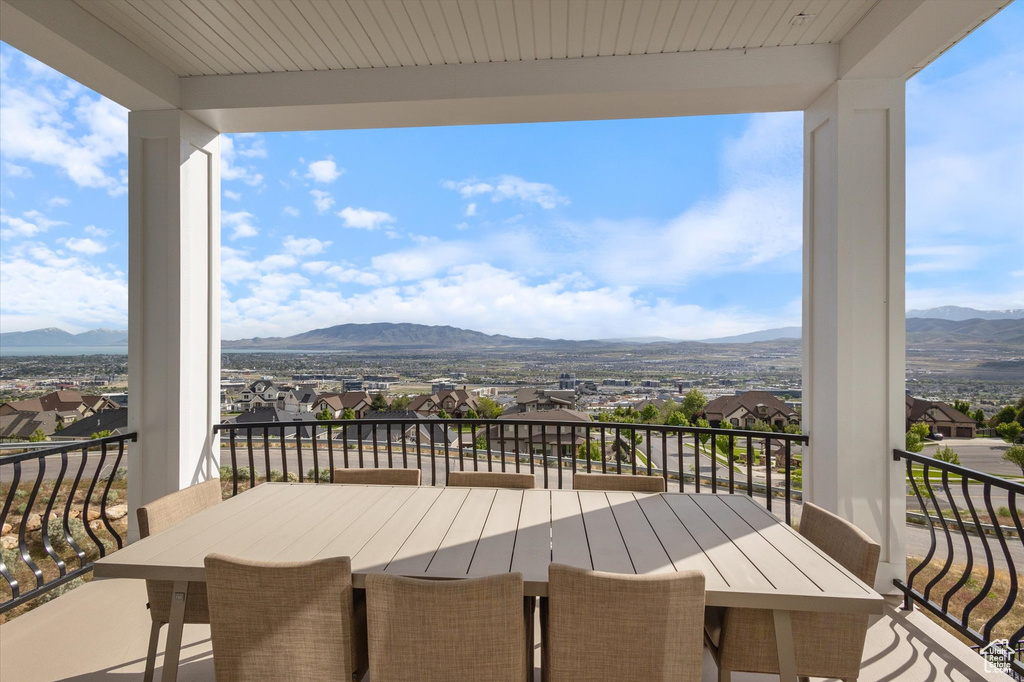 Wooden deck with a mountain view, a residential view, and outdoor dining area