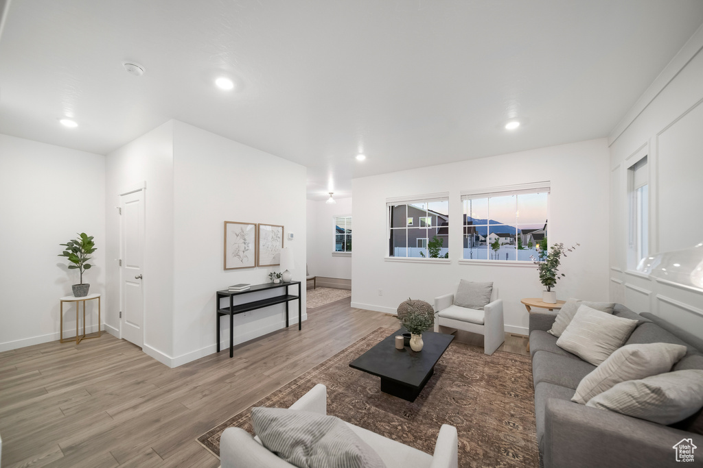Living area with recessed lighting and light wood-style floors