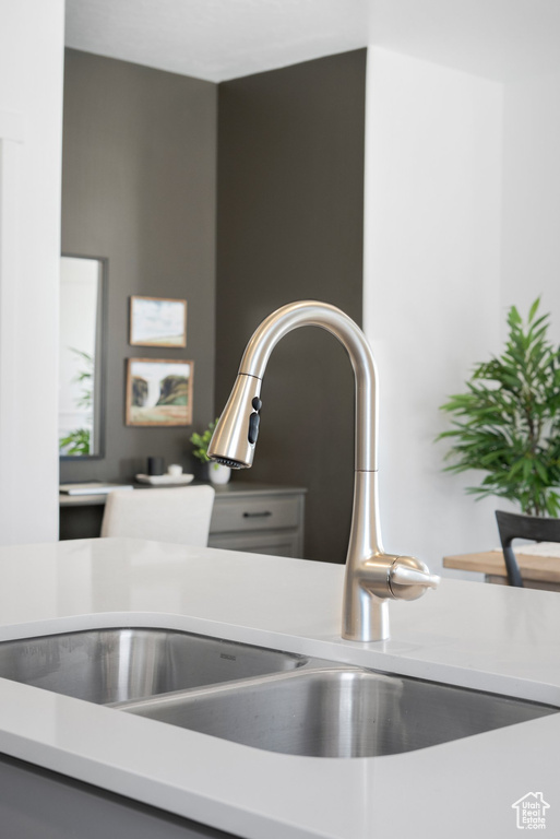 Room details with a sink and light countertops