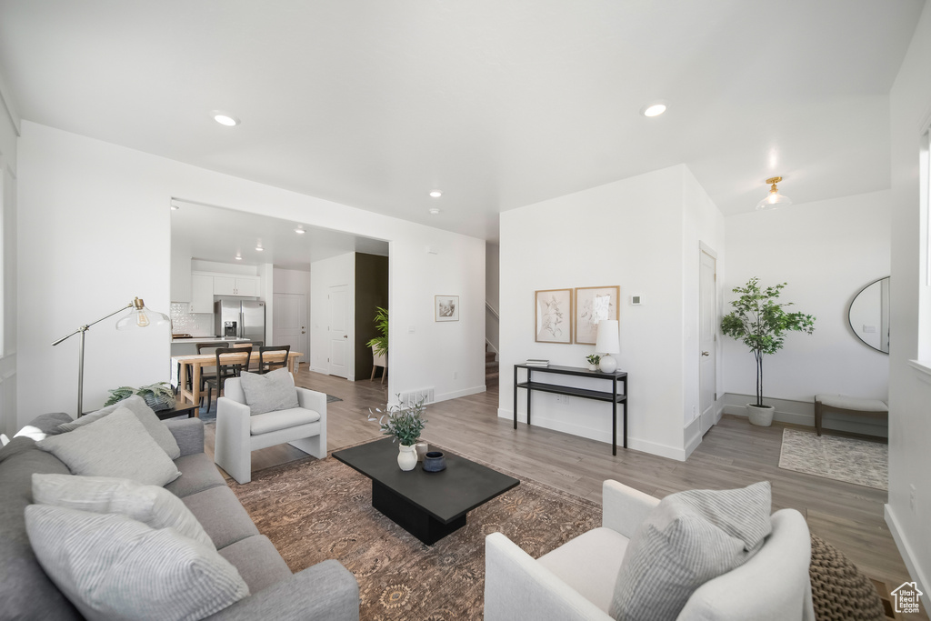 Living area with light wood-type flooring, recessed lighting, and baseboards