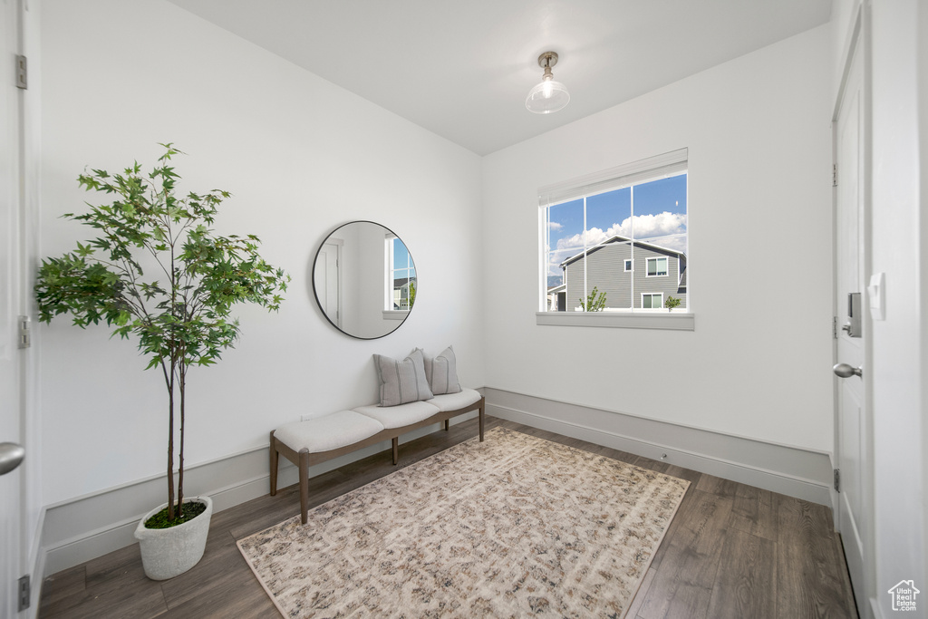 Living area with baseboards and wood finished floors