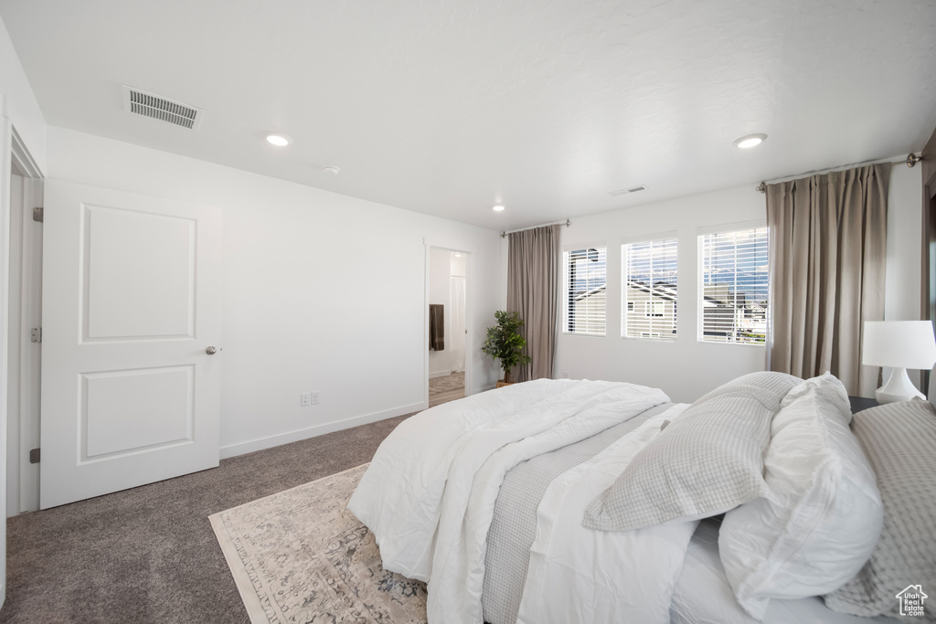 Bedroom featuring carpet flooring, recessed lighting, and visible vents