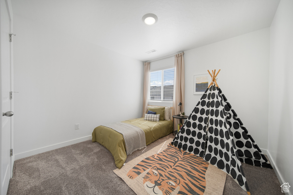 Bedroom featuring carpet flooring and baseboards