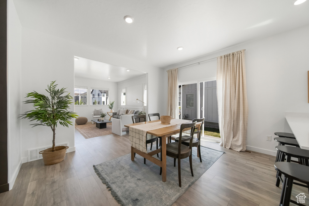 Dining room featuring recessed lighting, light wood finished floors, and baseboards