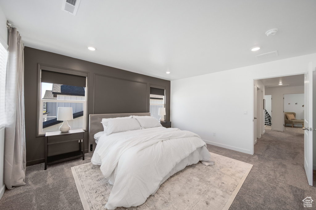 Carpeted bedroom with recessed lighting, baseboards, and visible vents