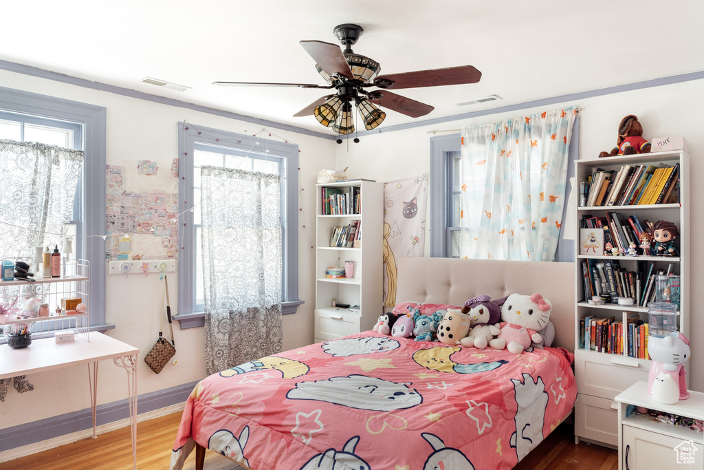 Bedroom with wood finished floors and a ceiling fan