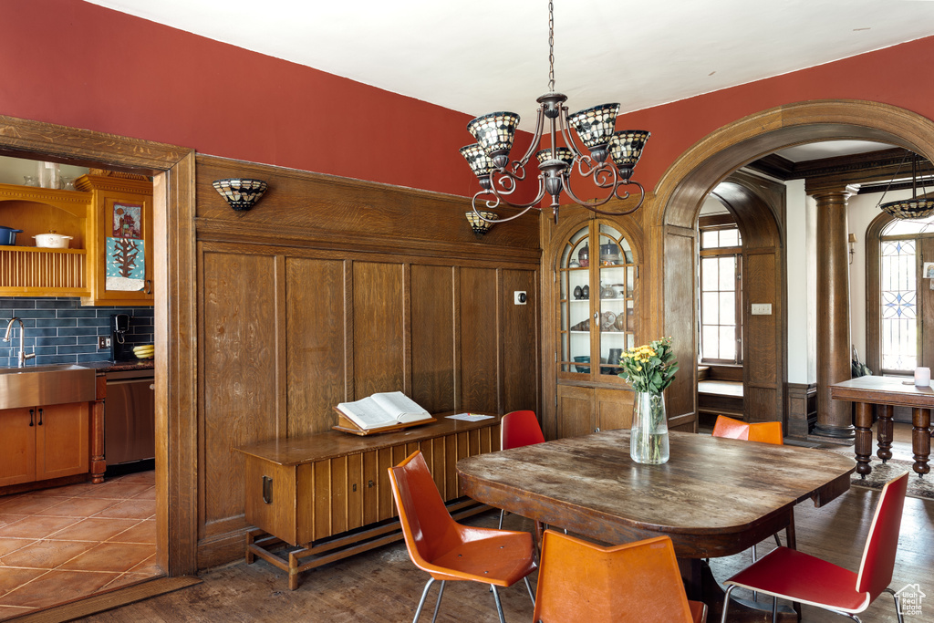 Dining room featuring arched walkways and a chandelier