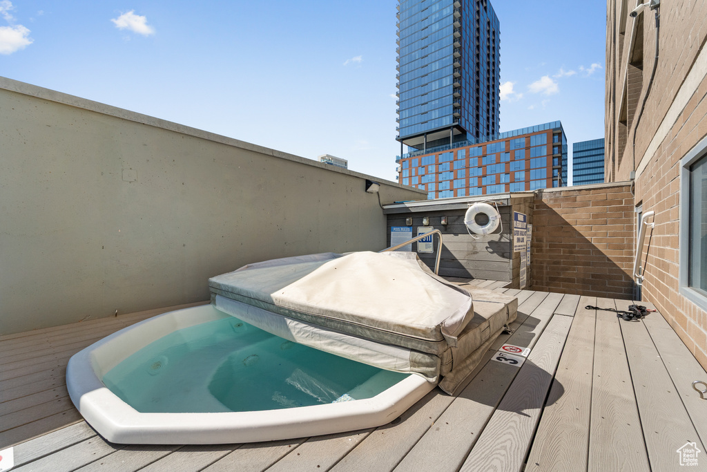 View of swimming pool featuring a covered hot tub