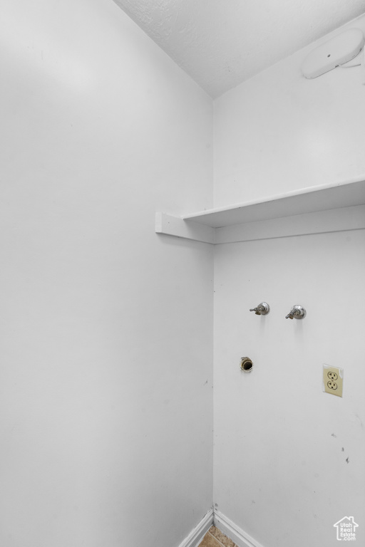 Washroom featuring baseboards and washer hookup