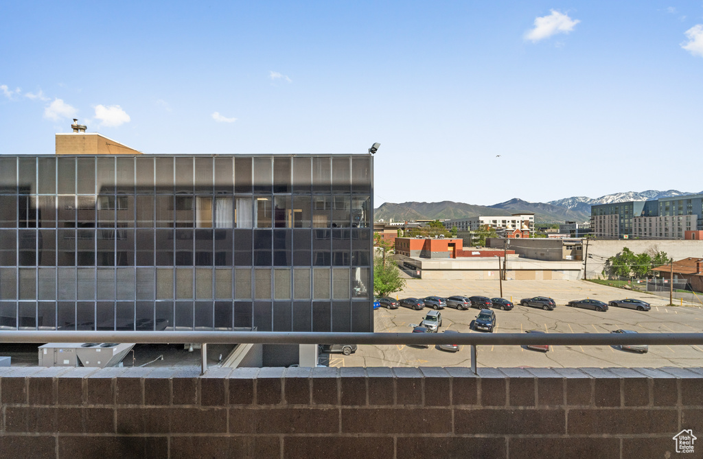 View of building exterior with a mountain view and uncovered parking