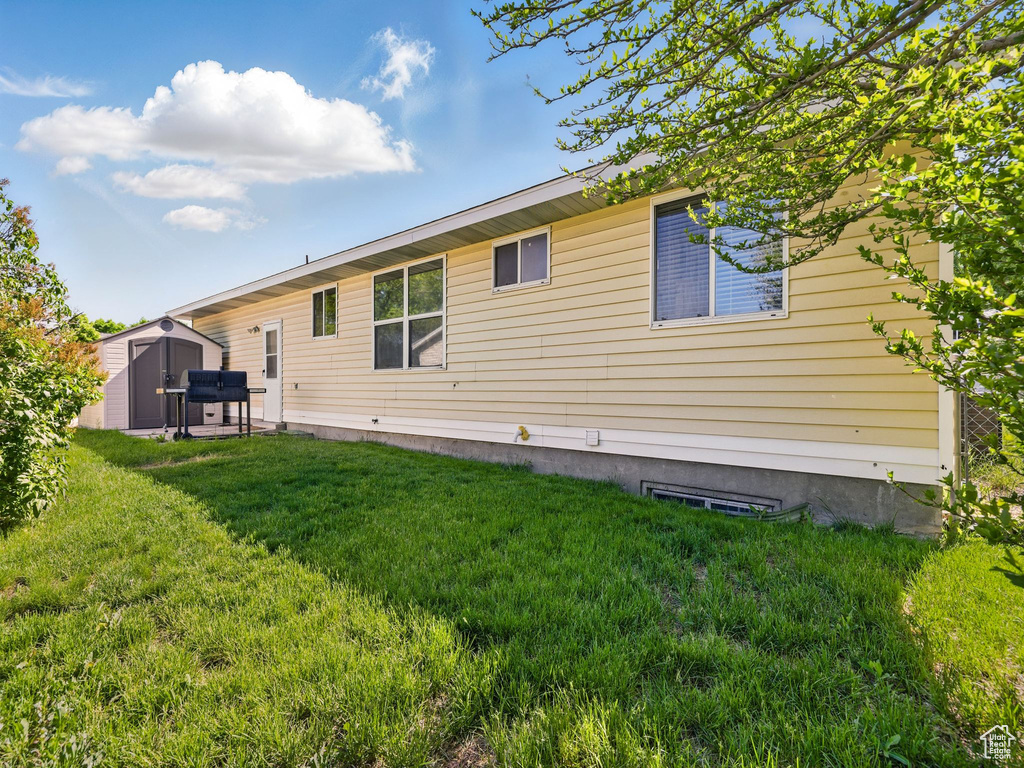 Back of property featuring a yard