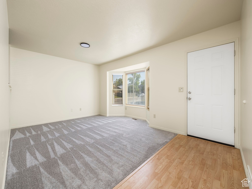 Unfurnished room with baseboards and wood finished floors