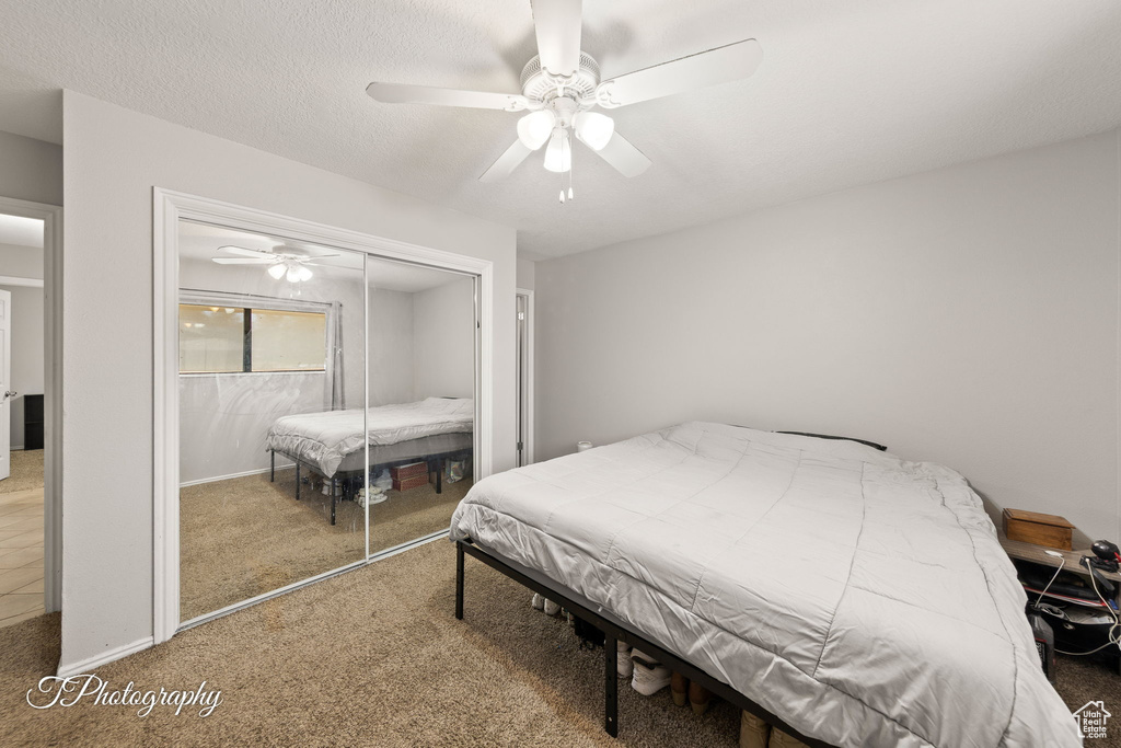 Bedroom with carpet flooring, a closet, and ceiling fan
