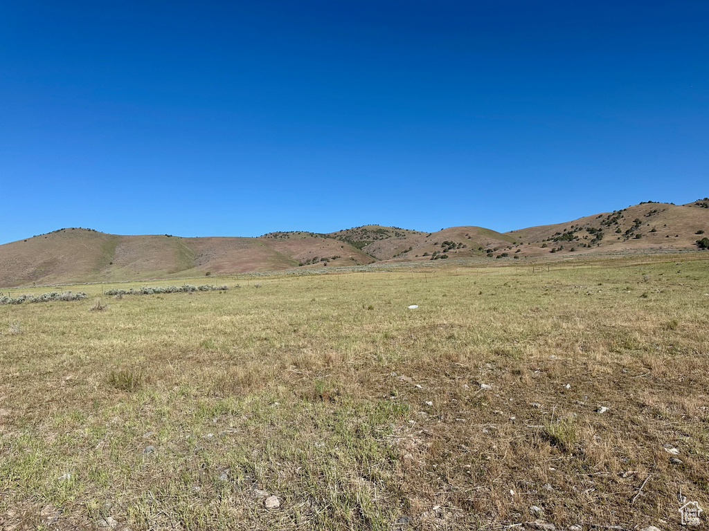 View of mountain backdrop featuring rural landscape