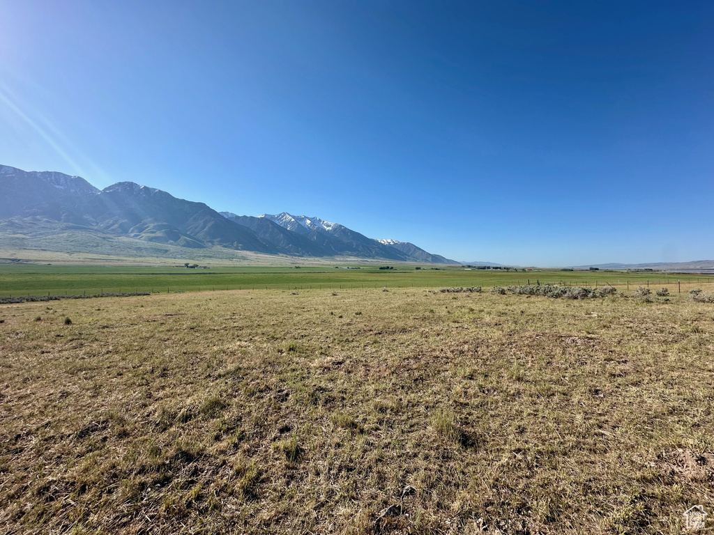 View of mountain backdrop with rural landscape