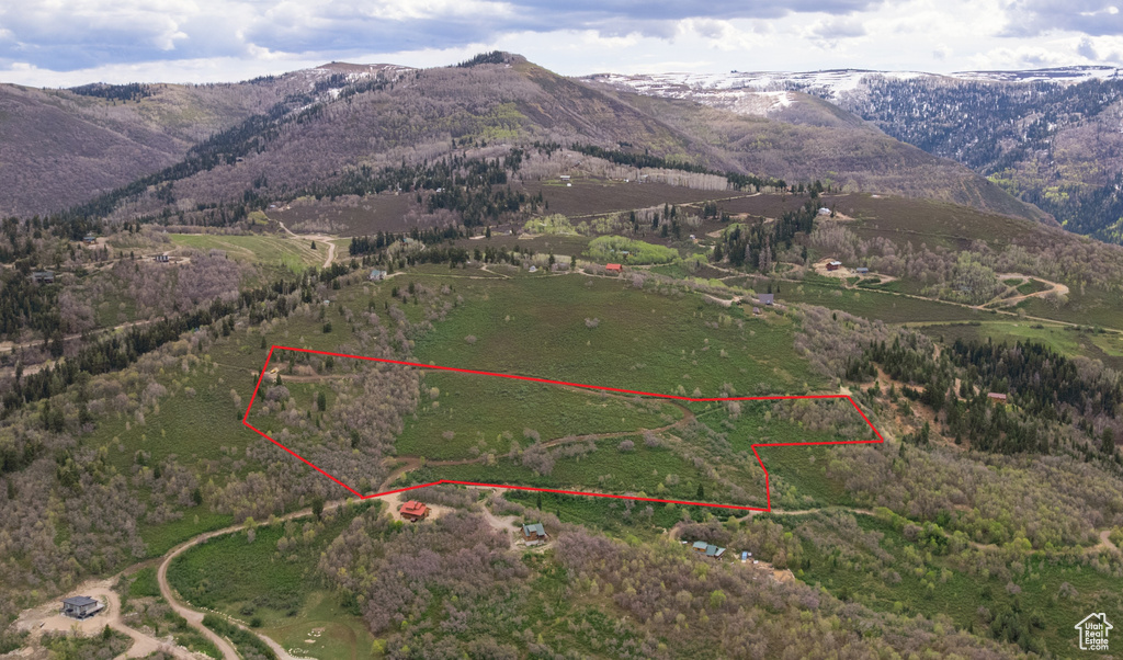 View of rural area featuring a mountain backdrop and property boundaries highlighted