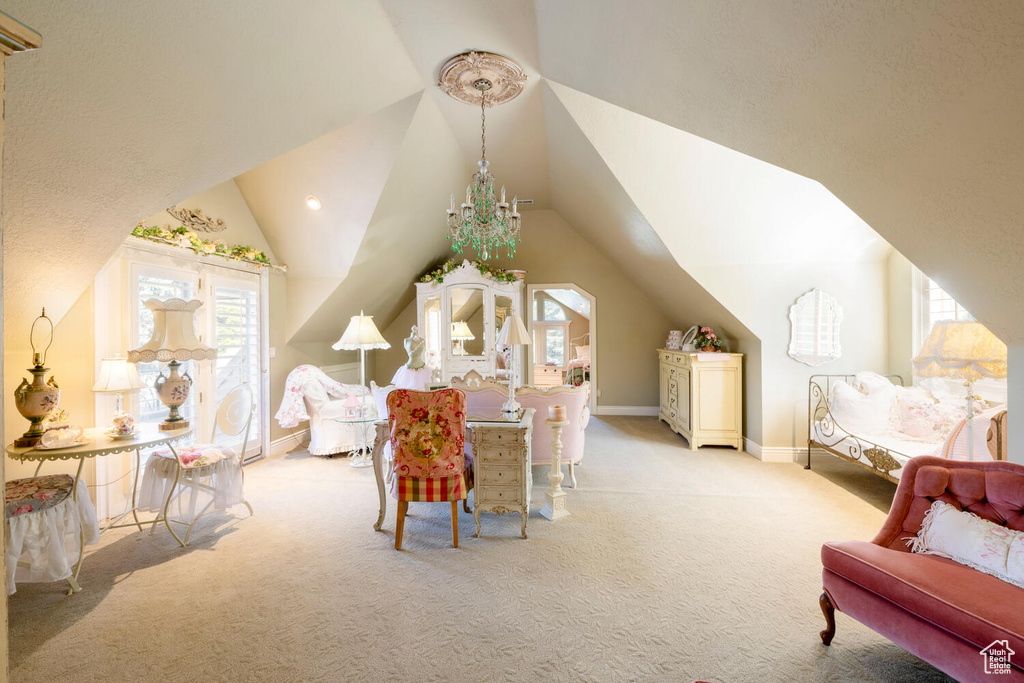 Interior space with baseboards, vaulted ceiling, and carpet flooring