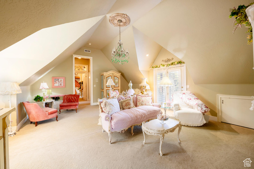 Interior space with vaulted ceiling, carpet, visible vents, and baseboards