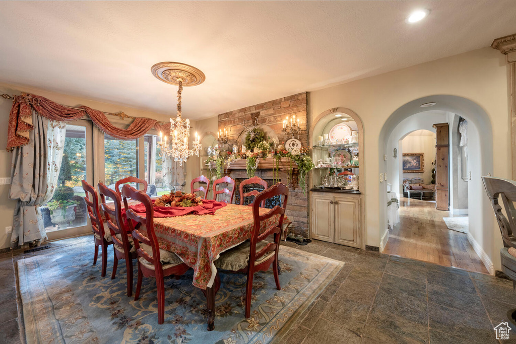 Dining area featuring arched walkways and a notable chandelier