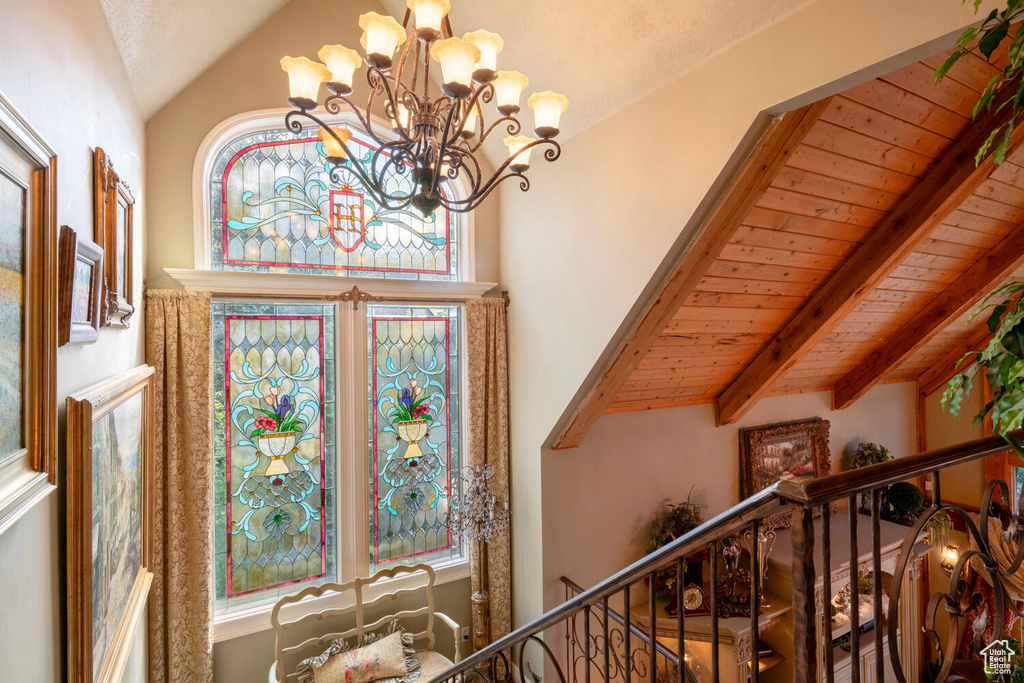 Foyer featuring a chandelier, wood ceiling, and vaulted ceiling with beams