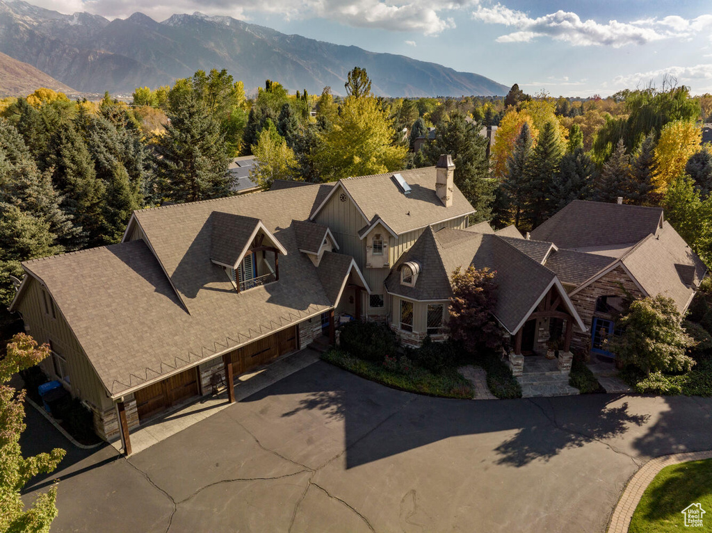 Drone / aerial view featuring a mountain view and a view of trees