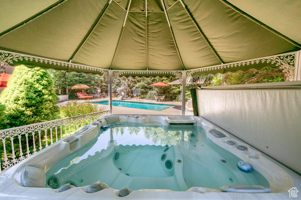 Pool featuring a hot tub