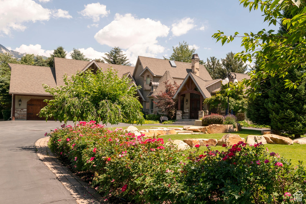 Tudor house with stone siding and concrete driveway